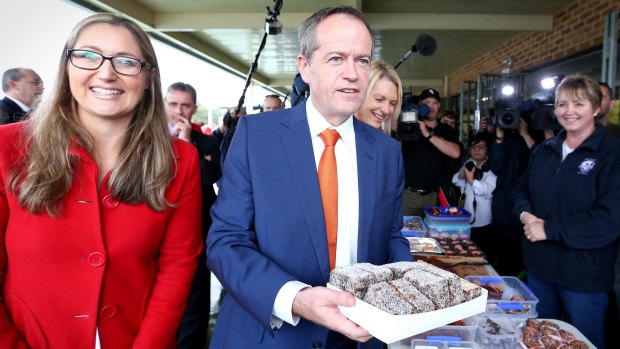 ALP candidate for Dobell Emma McBride, Opposition Leader Bill Shorten and ALP candidate for Robertson Anne Charlton buy lamingtons during a visit to the Wyong District Netball Association on the NSW Central Coast.