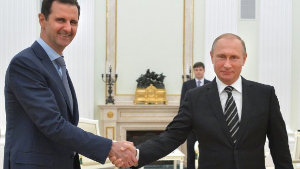 Firm ally ... Syrian President Assad shakes hands with Russian President Putin.
