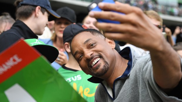 Hollywood actor Will Smith poses for selfies at the Stars' BBL game on Saturday evening.