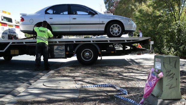 A car is removed from the house by ACT Policing on Thursday.