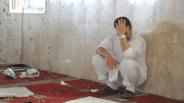A family member of a slain victim mourns after arriving at the Imam Ali mosque, the site of a suicide bomb attack, in the village of al-Qadeeh in the eastern province of Gatif, Saudi Arabia on Friday.