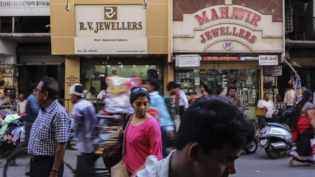 Pedestrians walk past jewellery and bullion stores in the Zaveri Bazaar in Mumbai, India, on Monday.