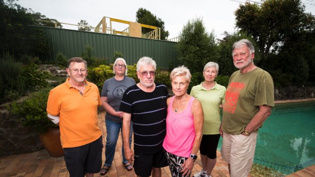 Residents John Hill, Alexandra Geue, Russell Johnson, Joan Johnson, Margaret Cooper and John Cooper are concerned about the construction of a building on a former Mr Fluffy site. 