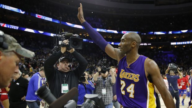 Kobe Bryant waves to the crowd after a game.