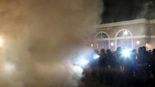 Police deploy tear gas on protestors during a demonstration in Ferguson.