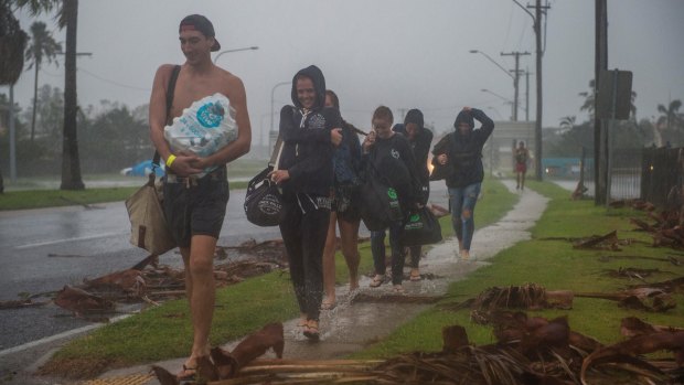 Backpackers from England, Germany and Finland leave the Bowen cyclone evacuation centre.