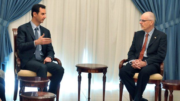 In this photo released by the Syrian official news agency SANA, Syrian President Bashar al-Assad meets with Australian professor Tim Anderson and a delegation including academics, researchers and activists in Damascus in 2013. 