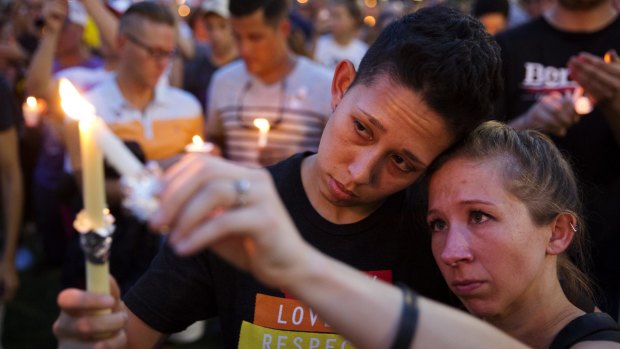 Jennifer, right, and Mary Ware light candles during a vigil for the victims of a mass shooting at Pulse nightclub in Orlando, Florida.