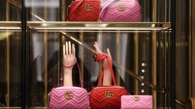 Pink and red leather GG Marmont matelasse luxury handbags on display. The scammer copied the Gucci brand among others.
