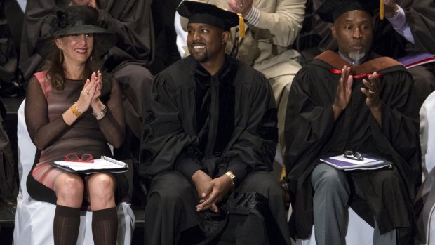 Kanye West smiles before receiving an honorary doctorate degree from School of the Art Institute of Chicago.