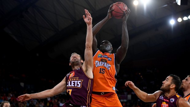 Nathan Jawai of the Taipans makes a jump shot over Anthony Petrie of the Bullets before the match was abandoned.