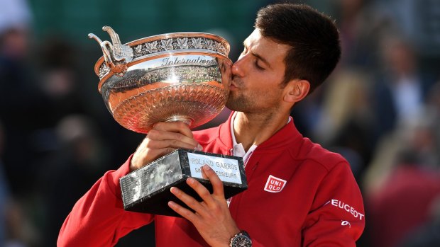 Two down, two to go: Djokovic with the French Open trophy.