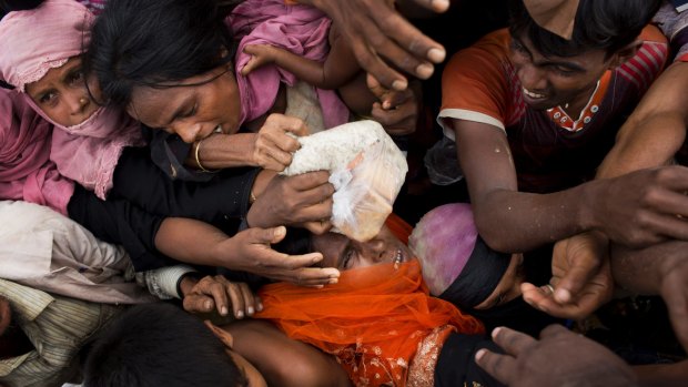 Rohingya Muslims scuffle for donated puffed-rice rations in Kutupalong, Bangladesh.