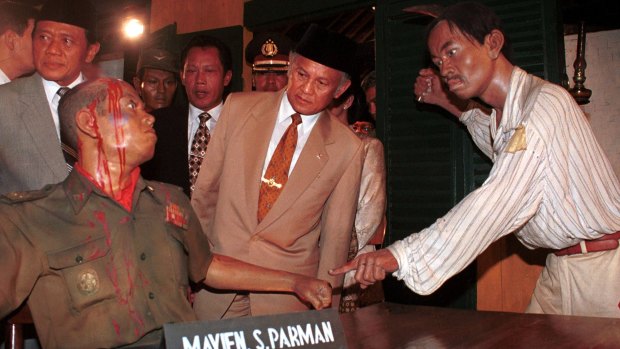 Then Indonesian president B.J. Habibie studies a diorama on the killing of six army generals that in turn sparked the 1965 massacres.