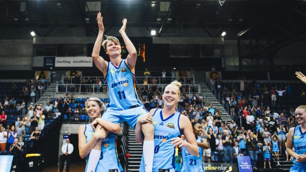 Jess Bibby is carried off by Canberra Capitals teammates Carly Wilson and Abby Bishop after her final WNBL game last season.