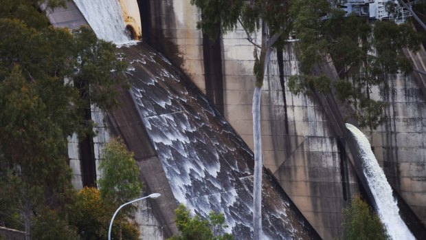 Water flows over the Warragamba Dam spillway on Thursday morning.