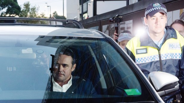 Ben McCormack, charged with a child pornography offence, leaves Redfern police station on Thursday evening. 