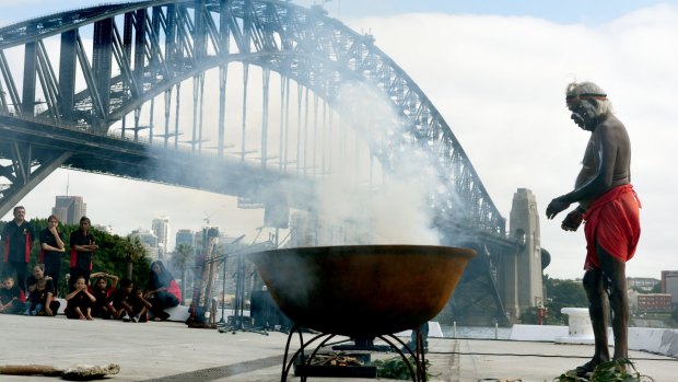 Uncle Max Eulo conducts a smoking ceremony during the official announcement of the Australia Day 2016 program.