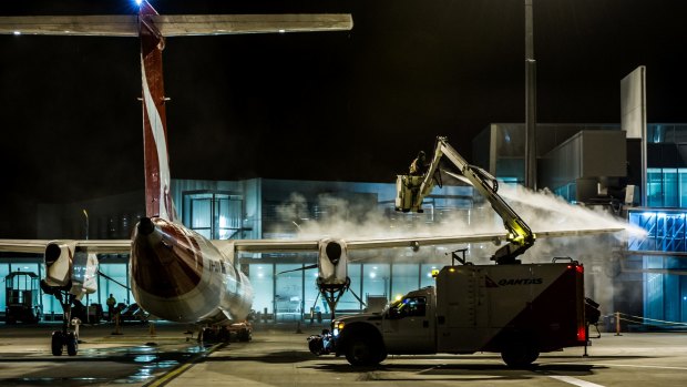 De-iceing work on the Qantas aircraft at Canberra airport in sub-zero temperatures. 