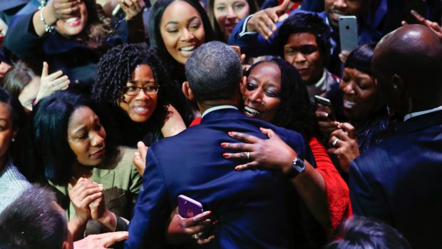 President Barack Obama is embraced by a woman in the crowd as he greets supporters after his farewell address.