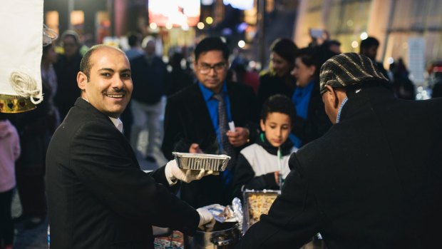 Hassan Muhammad serving Egyptian food at Ramadan Iftar on Saturday night.