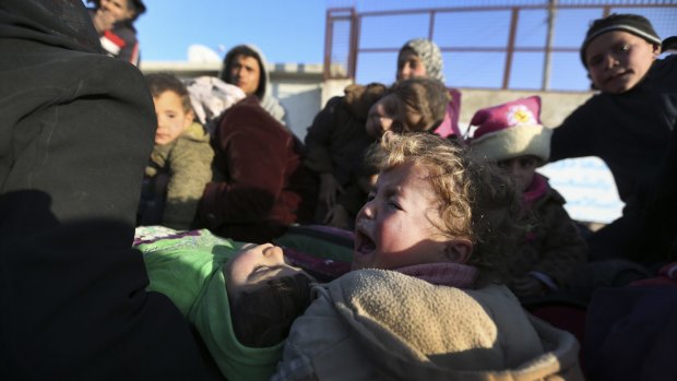 Syrians fleeing Russian air strikes arrive at the Bab al-Salam border crossing with Turkey.