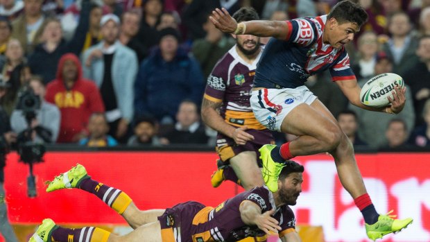 Jump and joy: Latrell Mitchell avoids the tackle of Ben Hunt to score the match-winner.