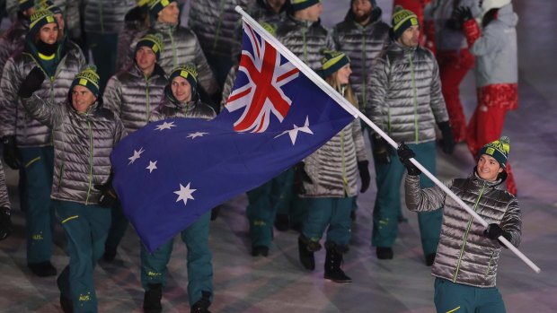 Proud moment: Scotty James carries the Australian flag into the arena.
