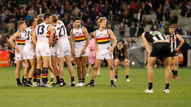 That sinking feeling: The Pies and Crows react after the draw.