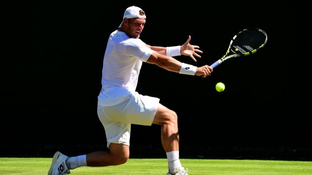 Sam Groth plays a backhand against Jack Sock of the United States.