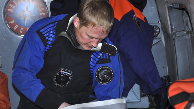 A Russian Emergency Situations Ministry officer checks equipment on board a helicopter during a rescue operation in the Sea of Okhotsk. The trawler Dalny Vostok sank about 4am local time, killing at least 56 fishermen.