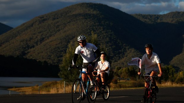Tony Abbott cycles into Talbingo accompanied by Talbingo residents 10-year-old Daniel Smith and 12-year-old Josh Smith. 