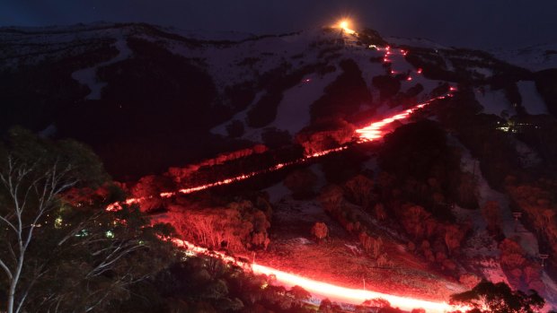 300 skiers conduct a flare run on the mountain at the Thredbo Alpine Village on Saturday, July 29, 2017. Eighteen people died when the Bimbadeen and Carinya Lodges were destroyed at Thredbo Alpine Village at 11:35 pm on Wednesday, July 30, 1997.