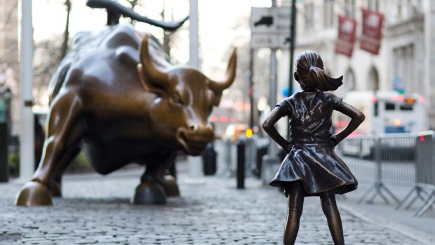 In this March 22, 2017 photo, the Charging Bull and Fearless Girl statues are shown on Lower Broadway in New York.