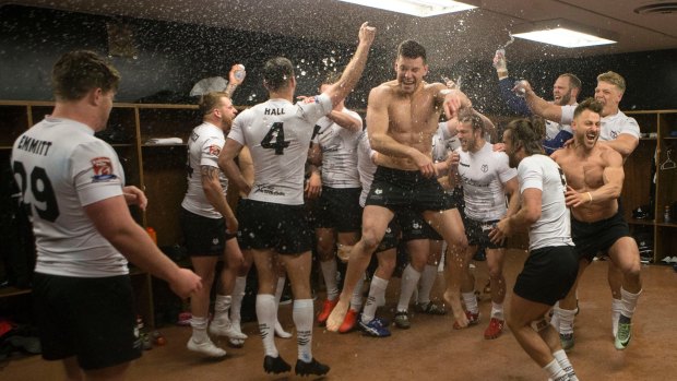 Off to a great start: Toronto Wolfpack players celebrate in the locker room after their 62-12 win over Oxford in their inaugural home game in League 1.