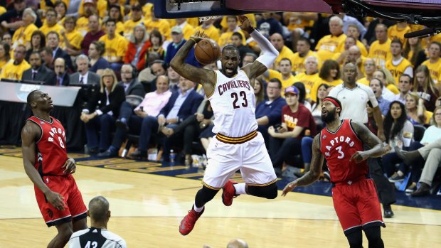 On top: Cleveland's LeBron James dunks the ball against the Toronto Raptors in game two of the NBA Eastern Conference finals.
