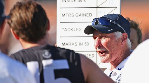 Carlton coach Mick Malthouse talks to his players during a break.