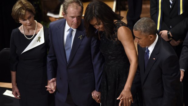 Former first lady Laura Bush, left, former President George W. Bush, first lady Michelle Obama, and President Barack Obama at the memorial service in Dallas.
