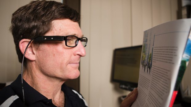 Roy Daniell is one of the first people in the ACT to try out the OrCam MyEye, a device that helps people with vision impairments. The device is clipped to the side of his glasses. 