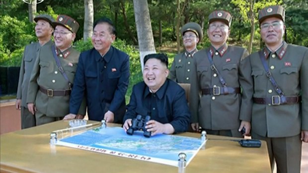 Kim Jong Un, centre, watches the test launch of missile at an undisclosed location in North Korea.