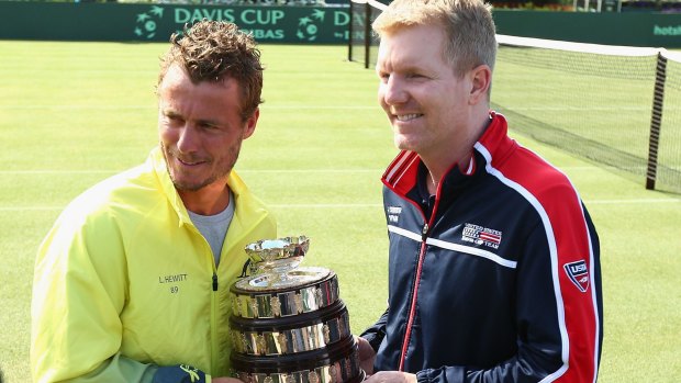 Lleyton Hewitt and Jim Courier pose with the cup during the official draw.