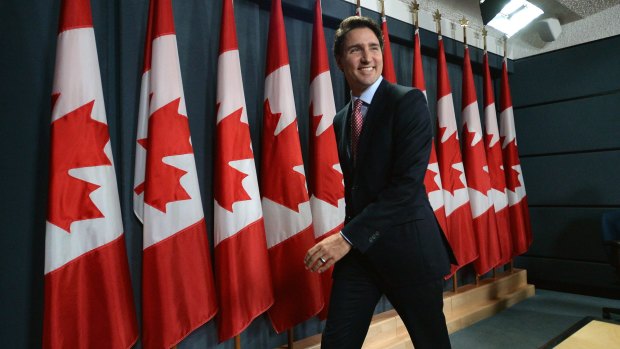 Prime Minister Justin Trudeau leaves his first media conference after winning the election in 2015.