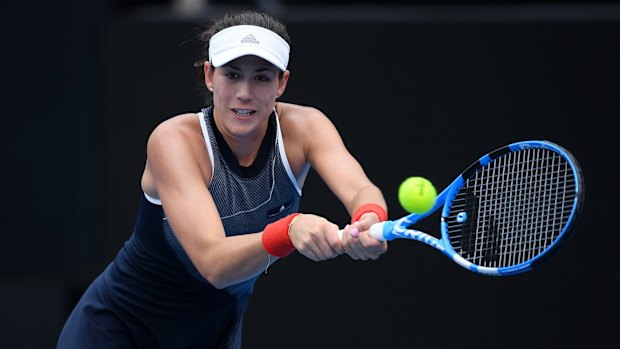 Garbine Muguruza overcame a leg injury to advance to the quarter-finals.