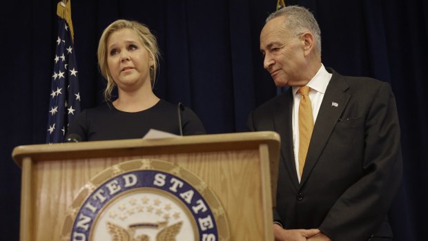 Actress Amy Schumer at a news conference withher distant cousin, New York Senator Chuck Schumer.