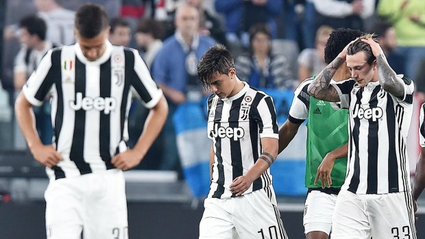 Paulo Dybala (centre) missed the penalty that would have secured Juve a point.