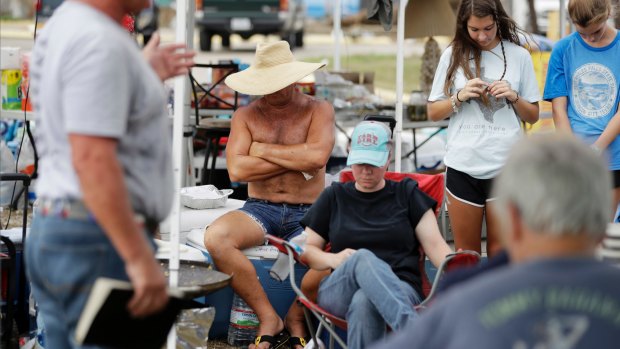 Worshipers attend a makeshift outdoor church service in the wake of Hurricane Harvey on  Sunday.