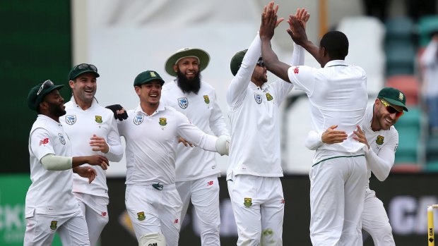 The South Africans celebrate with Kagiso Rabada, after he took Callum Ferguson's wicket on day four.