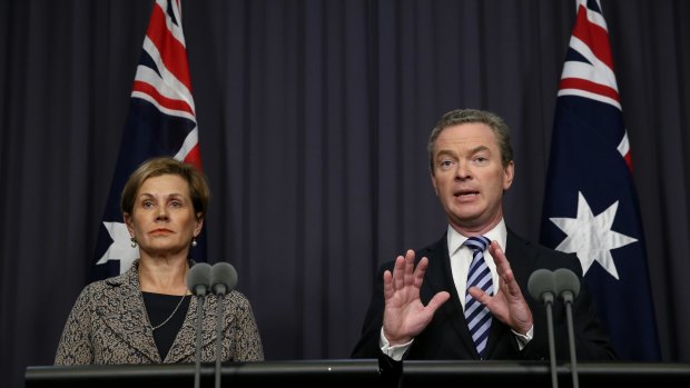Education Minister Christopher Pyne, pictured with Universities Australia chief executive Belinda Robinson, announces the backdown on Monday.