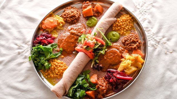 Skip the cutlery and use the injera as a scoop for the omnivore combination platter.