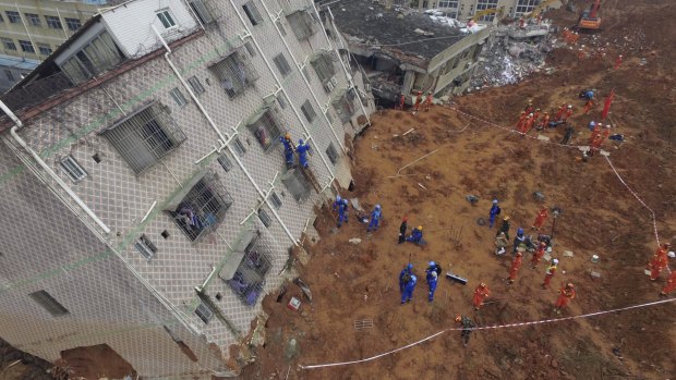 Rescue workers search for survivors in the aftermath of the landslide in Shenzhen.